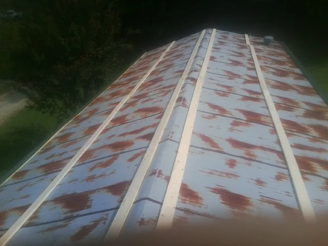 Rusted metal roof panels with new wood purlins before replacement — Storm Damage Roof Repair in Pompton Plains by Roofing Brothers