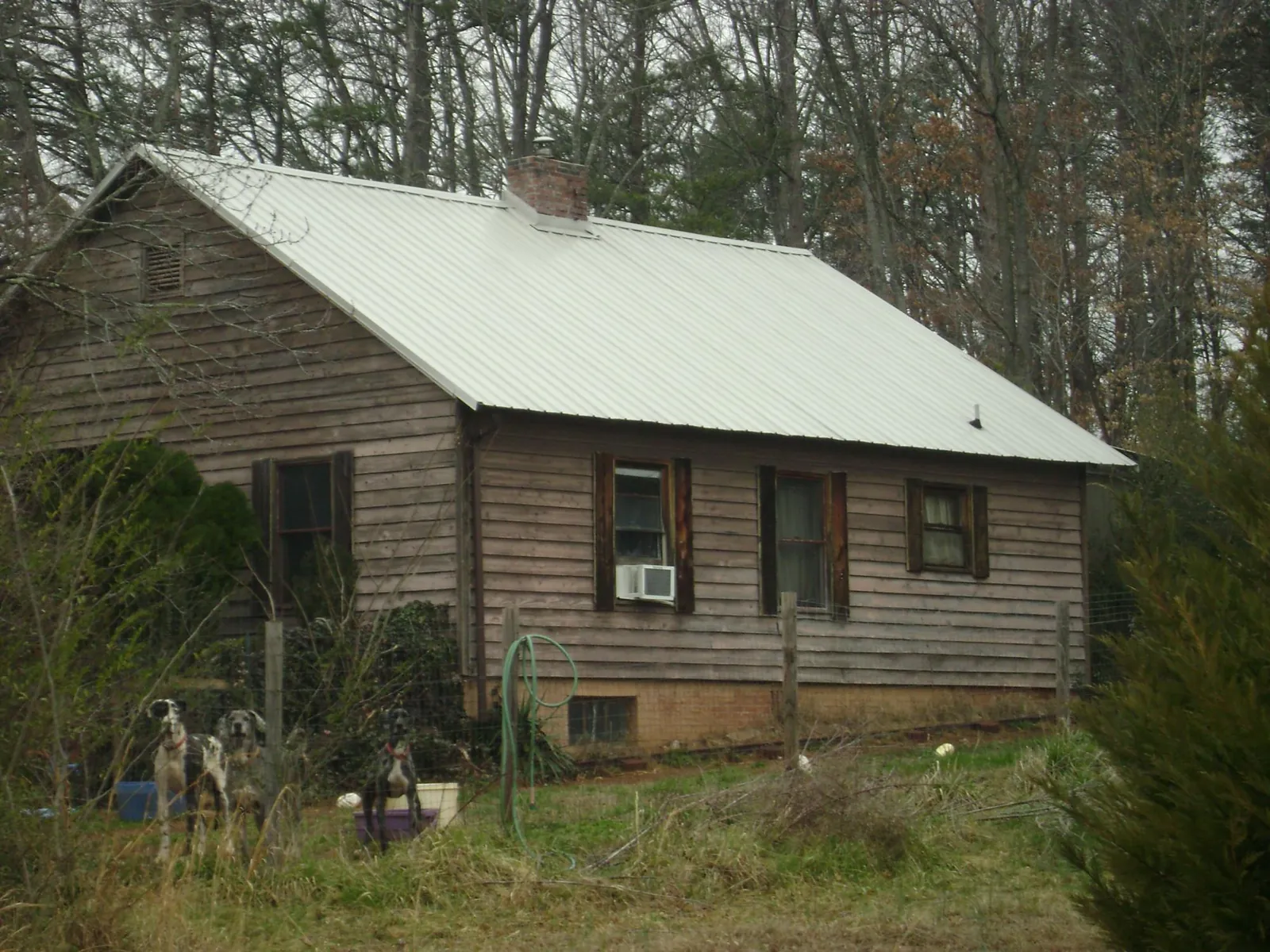 White metal roof on an old wood sided farmhouse, from a Metal Roof Installation job in Pompton Plains